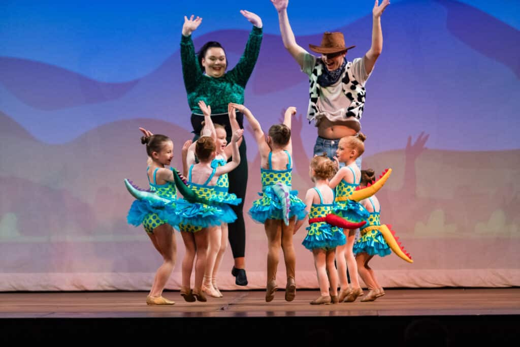 a group of preschool dancers jumping in happiness